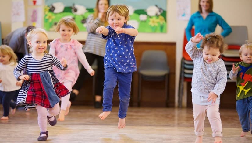 Kids dancing joyfully in a class